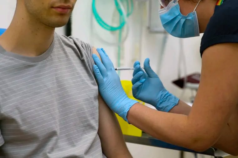 In this screen grab from video issued by Britain's Oxford University, a volunteer is injected with either an experimental COVID-19 vaccine or a comparison shot as part of the first human trials in the U.K. to test a potential vaccine.