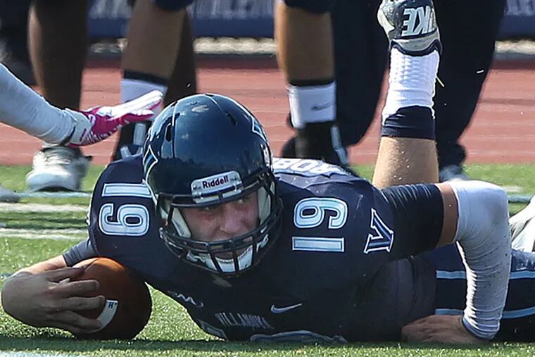 Villanova quarterback John Robertson is tackled while reaching for a first down. (Michael Bryant/Staff Photographer)