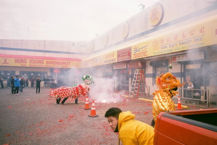 Depicted, a Lunar New Year Celebration scene at Wing Phat Plaza in South Philadelphia, one of the many images contributed to A Photographic Survey of Philadelphia by photographer Neema Kashi.