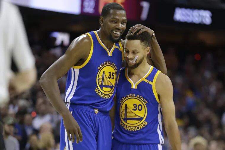 The Warriors’; Kevin Durant (35) hugs teammate Stephen Curry (30) during Game 4 of last year’s NBA Finals against the Cavaliers.