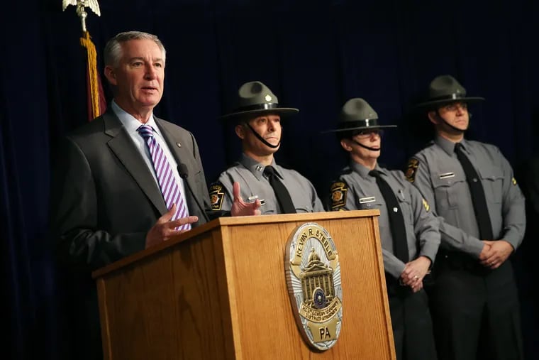 Montgomery County District Attorney Kevin Steele, left, stands with Pennsylvania State Troopers as he announces a first-degree murder charge against Nicholas Forman. Forman allegedly killed his girlfriend, Sabrina Harooni, after an argument Sunday night.