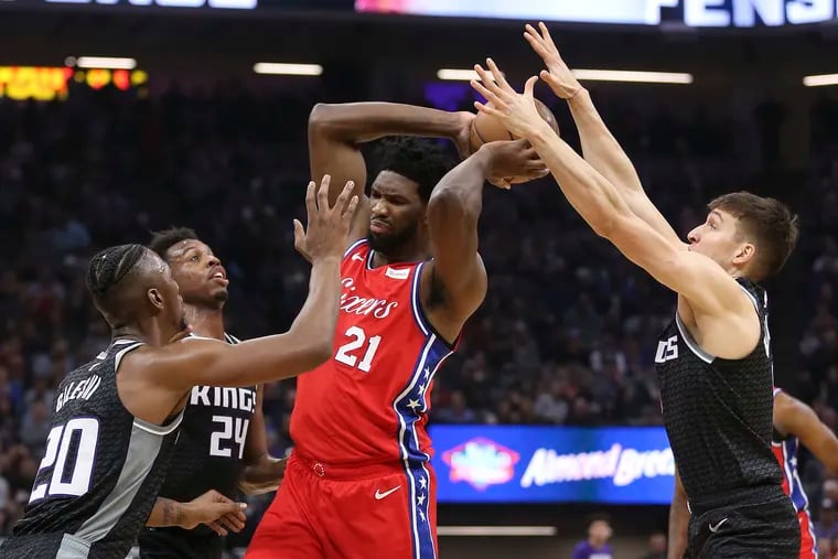 Joel Embiid fights off a triple-team by the Kings' Harry Giles (left), Buddy Hield and Bogdan Bogdanovic. He'll need some help if the Sixers are to go as deep into the playoffs as they should.