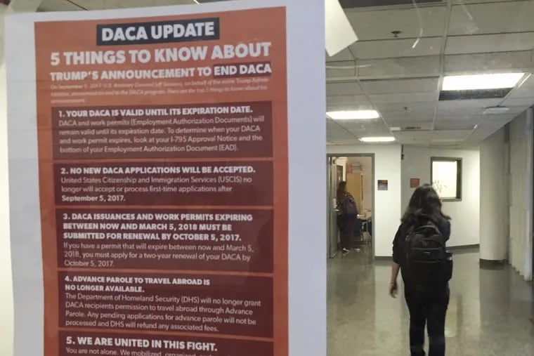 At the University of California, Berkeley, a student walks past a tip sheet for DACA recipients who fear deportation.
