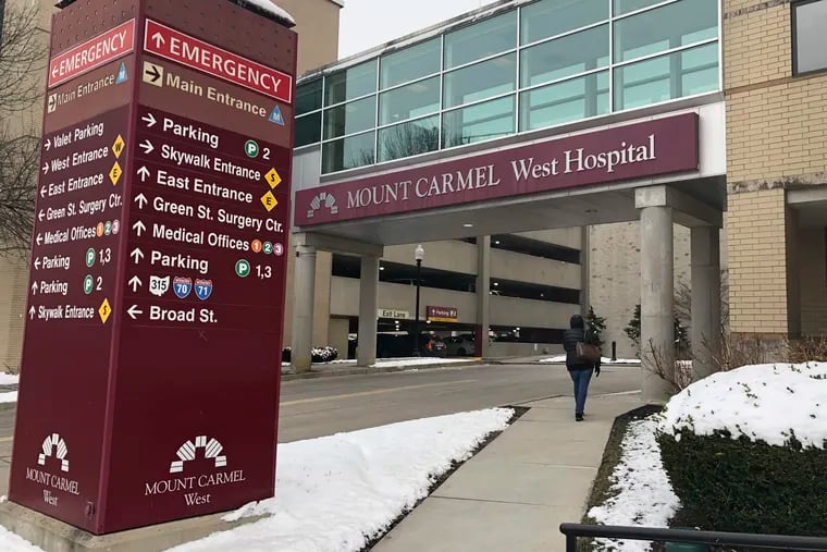 The main entrance to Mount Carmel West Hospital is shown Tuesday, Jan. 15, 2019. An intensive care doctor ordered "significantly excessive and potentially fatal" doses of pain medicine for over two dozen near-death patients in the past few years after families asked that lifesaving measures be stopped, an Ohio hospital system announced after being sued by a family alleging a dose of fentanyl hastened a woman's death. The Columbus-area Mount Carmel Health System said it fired the doctor, reported its findings to authorities and removed multiple employees from patient care pending further investigation, including nurses who administered the medication and pharmacists. (AP Photo/Andrew Welsh Huggins)