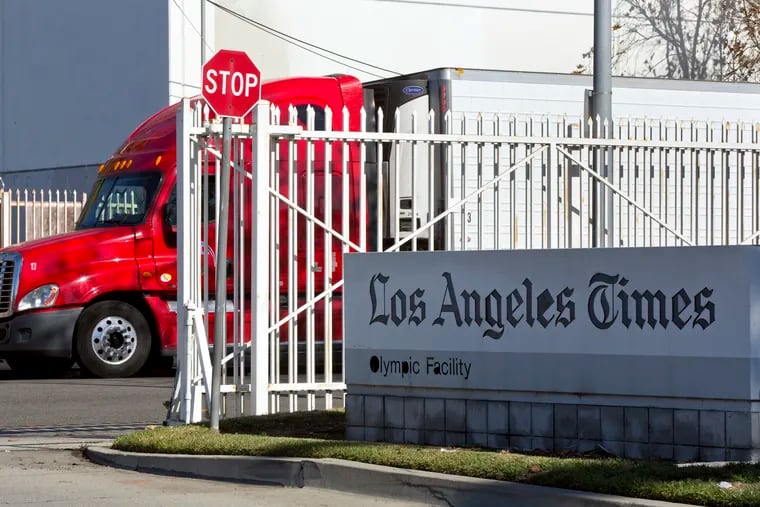A truck is parked outside the Los Angeles Times Olympic Facility in Los Angeles, Sunday, Dec. 30, 2018. A computer virus hit the newspaper printing plant in Los Angeles, and at Tribune Publishing newspapers across the country. (AP Photo/Damian Dovarganes)