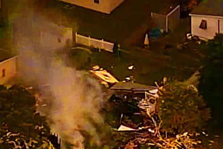 This frame from CBS video shows the remains of a house that exploded Nov. 7, 2013, in Cape May County.