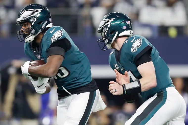 Josh Adams takes the handoff from Carson Wentz during the Eagles' loss to the Cowboys this week.