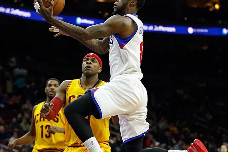 Tony Wroten drives to the basket against the Cavaliers' Brendan Haywood. (Yong Kim/Staff Photographer)