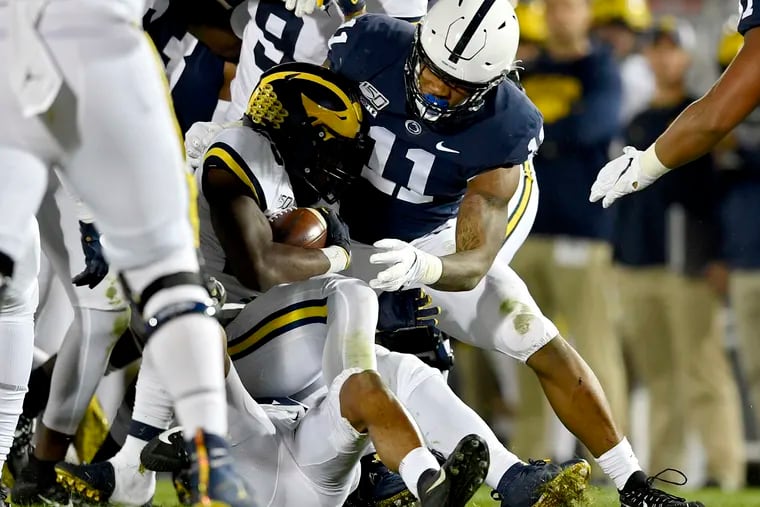 Penn State linebacker Micah Parsons (11) stops a Michigan ball carrier on Saturday, Oct. 19, 2019, at Beaver Stadium in University Park, Pa. The host Nittany Lions won, 28-21.