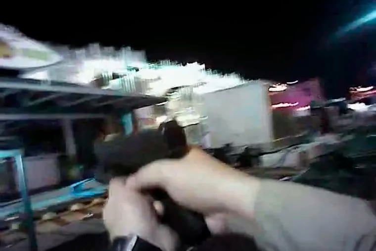 FILE - In this Sunday, Oct. 1, 2017, file image taken from police body cam video released by the Las Vegas Metropolitan Police Department on July 25, 2018, an armed law enforcement official points his gun while searching for a shooter in Las Vegas. Police in Las Vegas said Thursday, Jan. 3, 2019, they have finished releasing audio, video and written records about the investigation of the deadliest mass shooting in modern U.S. history. (Las Vegas Metropolitan Police Department via AP, File)
