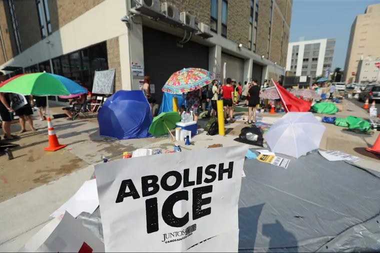 Establishing a small encampment for a possibly prolonged occupation, protesters have gathered outside the Immigration and Customs Enforcement office in Center City to demand an end to the agency's policies and cooperation between the city of Philadelphia and ICE, Tuesday July 3, 2018. DAVID SWANSON / Staff Photographer .
