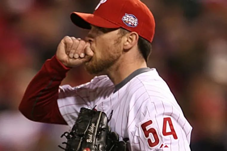 Brad Lidge blows on his hands after giving up the game-deciding double to Alex Rordriguez in the ninth ining. (Yong Kim/Staff photographer)