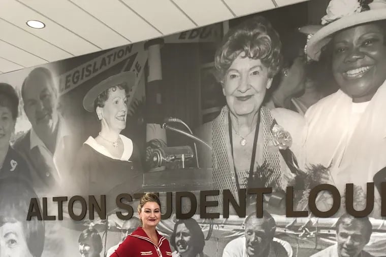 Karen Alton standing in front of a mural dedicated to her grandmother, Elizabeth B. Alton, on Stockton University's Atlantic City campus.