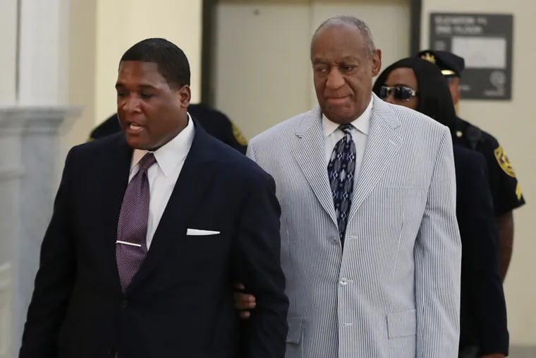 Bill Cosby, right, is led into the courtroom in the Montgomery County Courthouse by one of his aides, on Tuesday, Sept. 6.