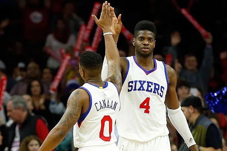 Nerlens Noel and Isaiah Canaan celebrate their win over the Atlanta Hawks. (Yong Kim/Staff Photographer)