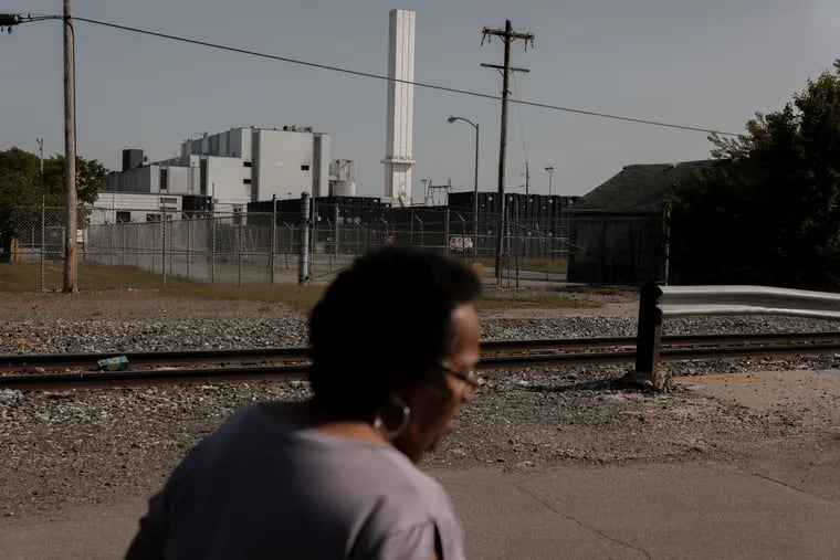 Zulene Mayfield walks on a residential street near the Covanta incineration facility in Chester.