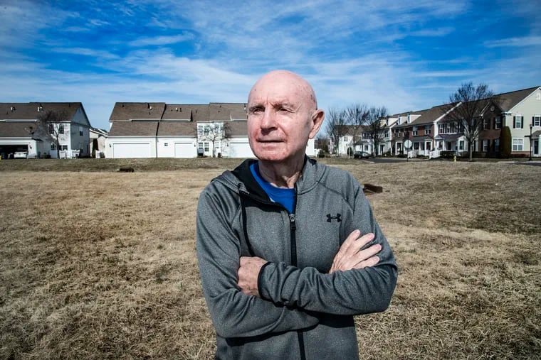 Ray Gunther, president of the homeowners association, stands on vacant land adjacent to the Centennial Mill retirement community in Voorhees, N.J. A proposal to build a think tank for world peace on the the site has many association members concerned that such a facility could disrupt life in their close-knit neighborhood.
