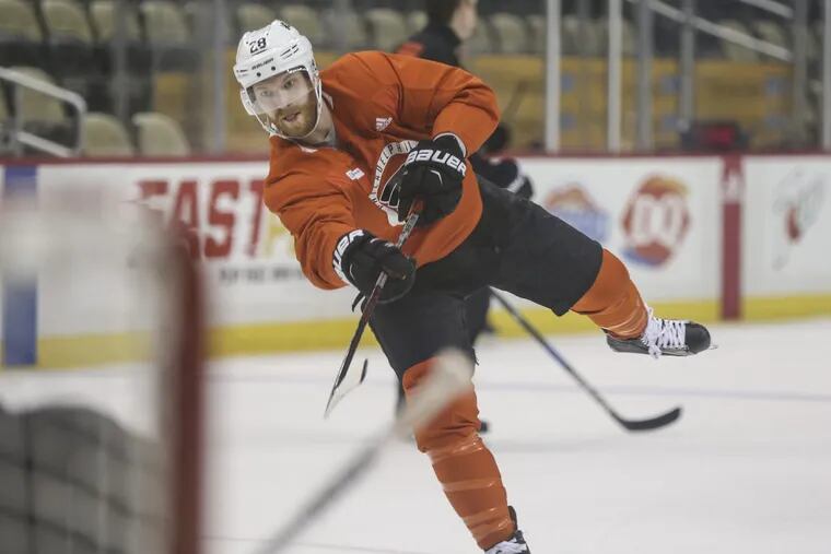 Captain Claude Giroux, shown taking a shot during Thursday’s practice, did not receive disciplinary action for his so-called hit on Pittsburgh’s Kris Letang during the Flyers’ 5-1 win Friday. The Flyers evened the series at one win apiece.