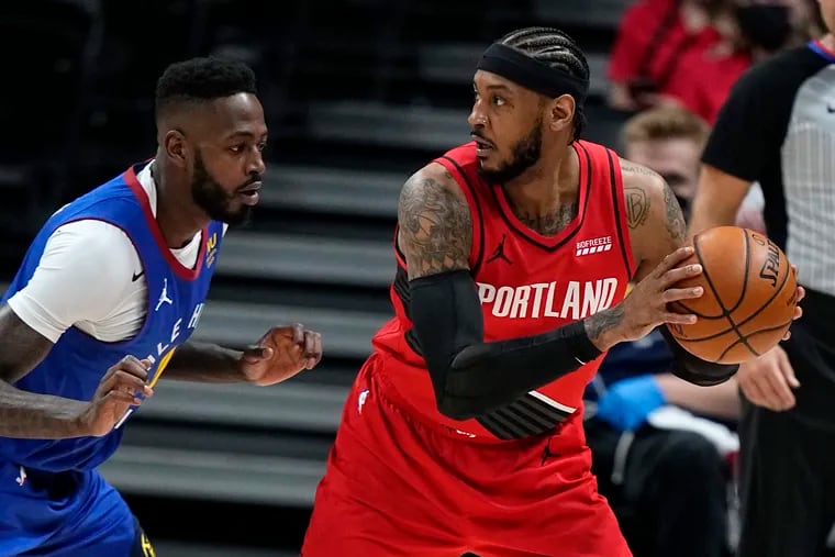 Portland Trail Blazers forward Carmelo Anthony keeps the ball from Denver Nuggets forward JaMychal Green during the first half of Game 5 of a first-round NBA playoff series.