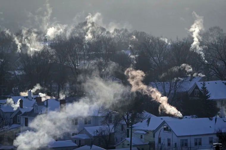 FILE- In this Wednesday Jan. 30, 2019, file photo smoke rises from the chimneys of homes in St. Paul, Minn. While the polar vortex is driving up demand for natural gas, it isn’t doing the same for the price. The massive weather system is blanketing much of the Midwest and Northeast in a deep freeze, and demand for natural gas is spiking as homeowners crank up the heat to stay warm. 
Yet natural gas prices have fallen this week and are in the throes of a two-month skid. (Brian Peterson/Star Tribune via AP, File)