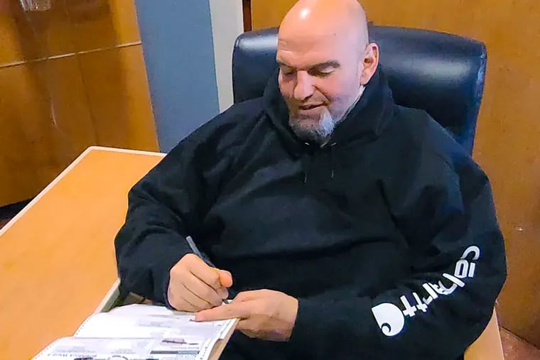 In this photo provided by the campaign, Lt. Gov. John Fetterman fills out his emergency absentee ballot for the Pennsylvania primary at the hospital on election day.