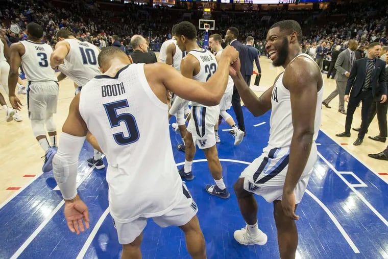 Seniors Phil Booth (left) and Eric Paschall celebrate after Villanova defeated Butler at the Wells Fargo Center on March 2, 2019.