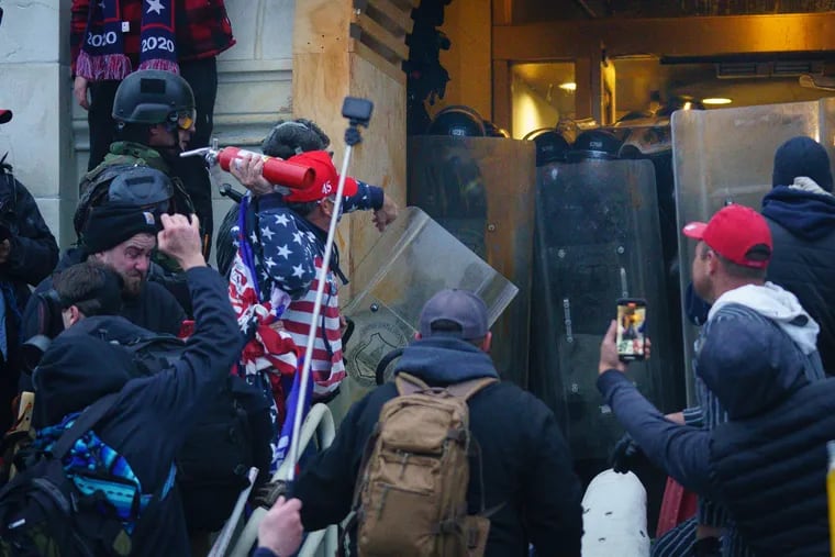 Rioters clashed with police in trying to enter a door at the U.S. Capitol in Washington on Jan. 6.