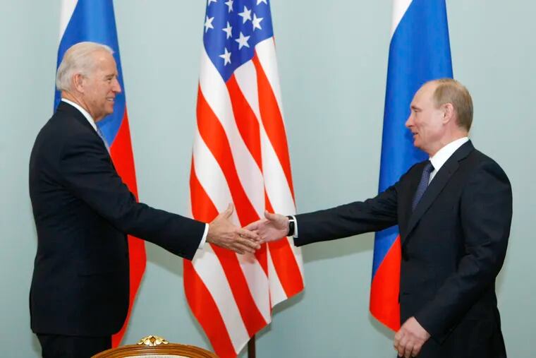 This March 10, 2011 photo shows then-Vice President Joe Biden, left, shaking hands with Russia's Vladimir Putin in Moscow.