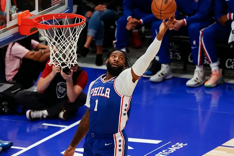Sixers center Andre Drummond reaches for the basketball against the Detroit Pistons in a preseason game on Friday, October 15, 2021 in Detroit.