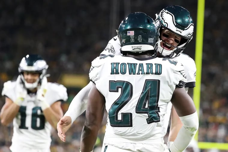 Eagles quarterback Carson Wentz, right, celebrates with running back Jordan Howard after Howard scored a touchdown in the 3rd quarter.
