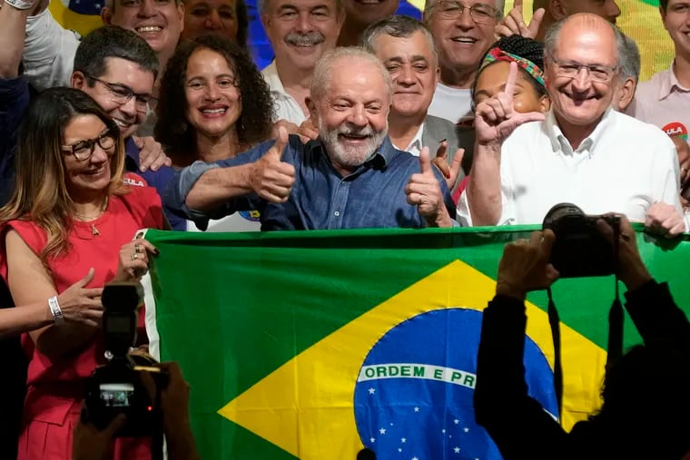 Luiz Inácio Lula da Silva celebrates with his wife, Rosângela da Silva (left), and running mate Geraldo Alckmin.