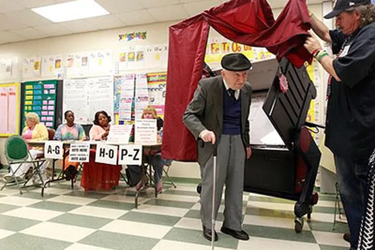 Patrick Parry, right, opens the curtain after Osias Garfunkel who cast his vote in the Union County primary elections at Elmora School No. 12, Tuesday, June 7, 2011 in Elizabeth, N.J. (AP Photo / Julio Cortez)