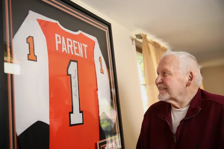 Legendary Flyers goaltender Bernie Parent stands for a portrait next to a framed jersey at his home in Warrington, Pa., on Tuesday, April 23, 2019. Parent, 74, is recovering from back surgery.
