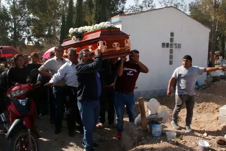 People prepare to bury a person who died in the gas pipeline explosion, in the village of Tlahuelilpan, Mexico, Sunday, Jan. 20, 2019. A massive fireball that engulfed locals scooping up fuel spilling from a pipeline ruptured by thieves in central Mexico killed dozens of people and badly burned dozens more on Jan. 18. (AP Photo/Claudio Cruz)