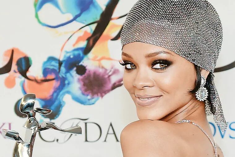 Fashion Icon Award honoree Rihanna poses with her award at the 2014 CFDA Fashion Awards at Alice Tully Hall on Monday, June 2, 2014, in New York. (Photo by Evan Agostini/Invision/AP)