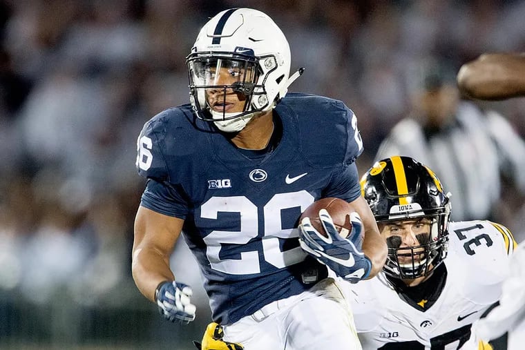 Penn State running back Saquon Barkley dodges Iowa's Brandon Snyder as he runs down the field for a touchdown on Saturday, Nov. 5, 2016, at Beaver Stadium in State College, Pa. Penn State won 41-14.