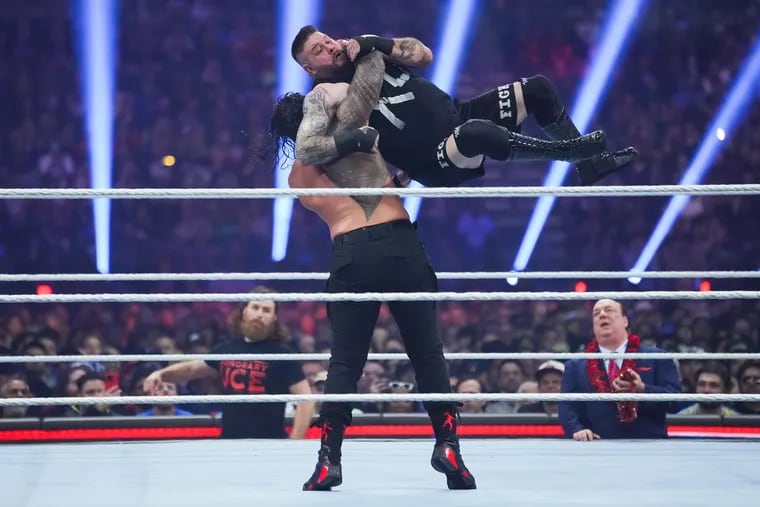 Roman Reigns and Kevin Owens wrestle during the WWE Royal Rumble event earlier this year. Next April, the WWE's signature event, WrestleMania, will return to Philadelphia after 25 years.