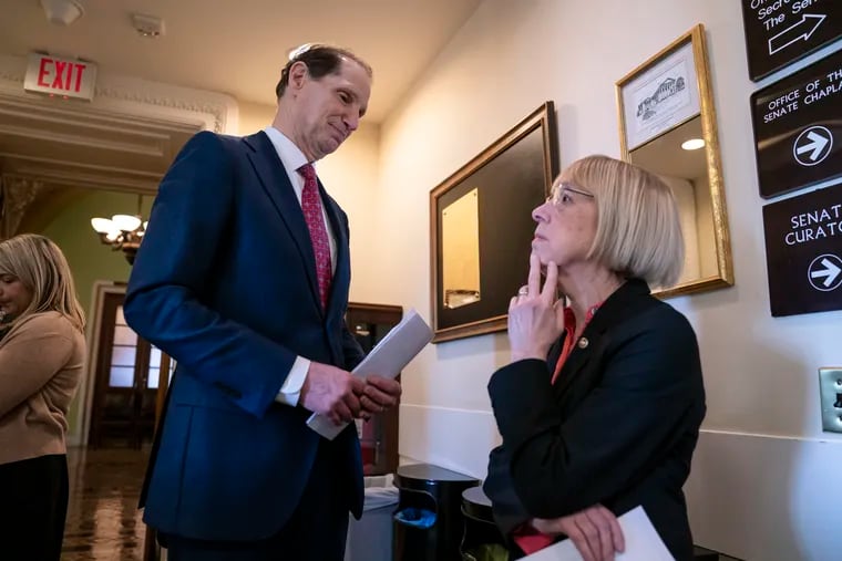 Sen. Ron Wyden, D-Ore., left, and Sen. Patty Murray, D-Ore., wait for Sen. Joe Manchin, D-W.Va., before a news conference to press Congress to intervene on behalf of the Affordable Care Act, after a federal judge in Texas ruled it unconstitutional, on Capitol Hill in Washington, Wednesday, Dec. 19, 2018. (AP Photo/J. Scott Applewhite)