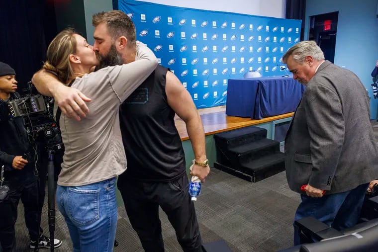 Jason Kelce kisses his wife, Kylie, after delivering an emotional retirement speech at the Eagles' NovaCare complex in Philadelphia on Monday.