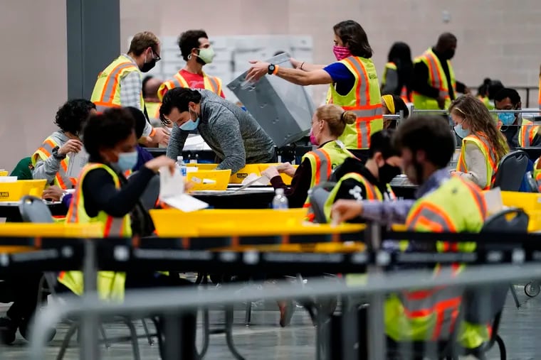 Philadelphia election workers process mail-in and absentee ballots for the 2020 general election in the United States at the Pennsylvania Convention Center, Tuesday, Nov. 3, 2020, in Philadelphia.