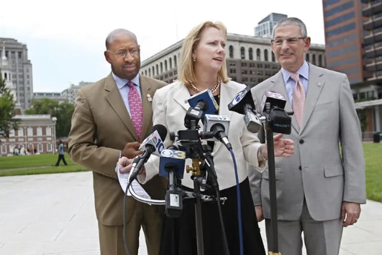 Flanked by Mayor Michael Nutter, left, and Robert J. Ciaruffoli, right, Donna Farrell, executive director of the World Meeting of Families Philadephia, center, stands on the Independence Mall and talks about Pope Francis' itinerary for his visit to the city, including Independence Hall.  (MICHAEL BRYANT / Staff Photographer)​