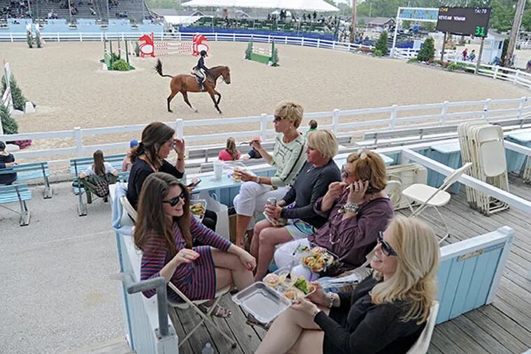 A group of ladies enjoys lunch in the private box of Carol McKiernan (top left of table) as a ride competes in the ring at the 118th annual Devon Horse Show and Country Fair on May 22, 2014.  ( CLEM MURRAY / Staff Photographer )