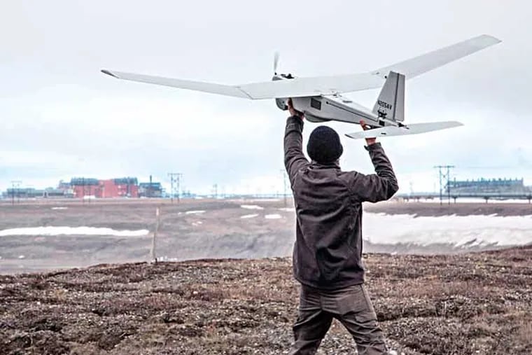 In this photo taken Saturday, June 7, 2014, and released by BP Alaska, Unmanned Aerial System (UAS) technology using an AeroVironment Puma drone is given a pre-flight checkout in preparation for flights by BP at its Prudhoe Bay, Alaska operations. The Federal Aviation Administration said Tuesday it has granted the first permission for commercial drone flights over land, the latest effort by the agency to show it is loosening restrictions on commercial uses of the unmanned aircraft. Drone maker AeroVironment of Monrovia, California, and BP energy corporation have been given permission to use a Puma drone to survey pipelines, roads and equipment in Alaska, the agency said. The first flight took place on Sunday. (AP Photo/BP Alaska)
