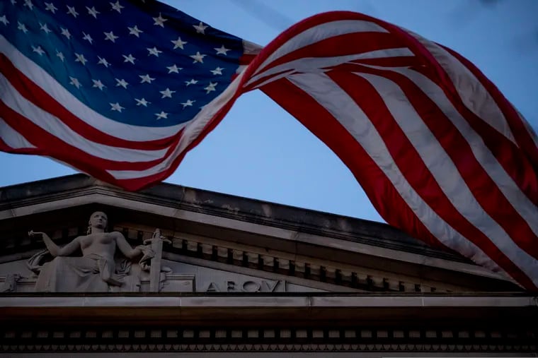 An American flag flies outside the Department of Justice in Washington, Friday, March 22, 2019.
