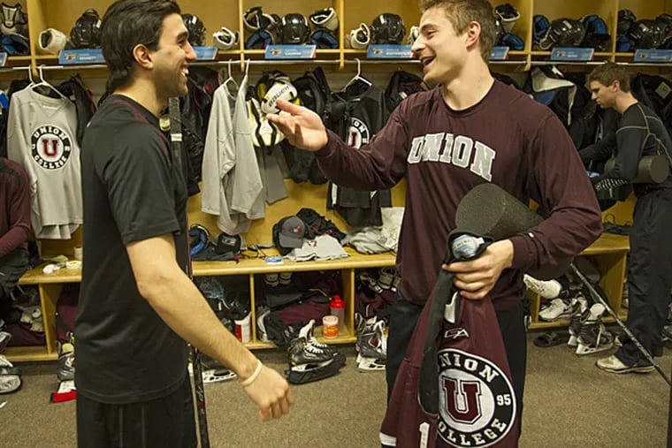 Union College hockey players Daniel Campini (left) and Max Novak chat in the locker room at the Wells Fargo Center before hitting the ice for their first practice at the Frozen Four in Philadelphia, April 9, 2014. (Clem Murray/Staf Photographer)