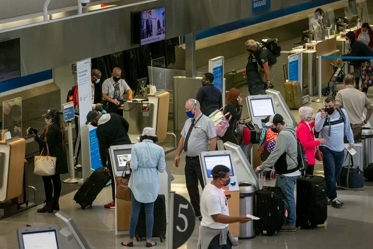 Travelers made their way through Terminal C at Philadelphia International Airport on Nov. 11, 2020.