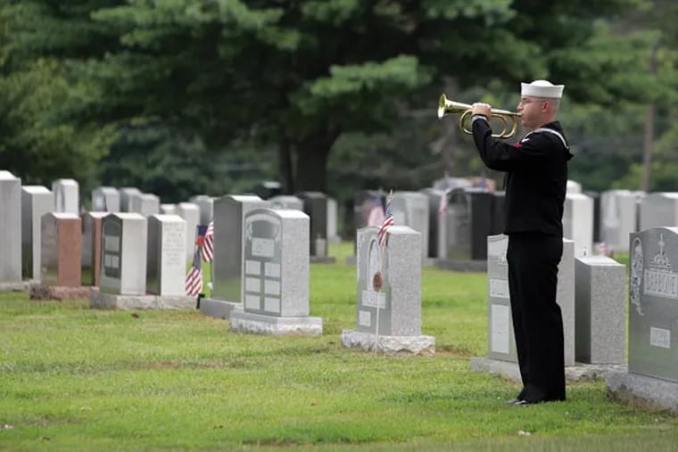 HM1 Navy Corpsman David Barthold play taps during the burial ceremony for Master Gunnery Sgt. Nicholas Formosa, at Saint Peter and Saint Paul Cemetery in Delaware County, on August 7, 2007. The Archdiocese of Philadelphia has leased 13 cemeteries to StoneMor Partners for $89 million. (Barbara L. Johnston/Inquirer)