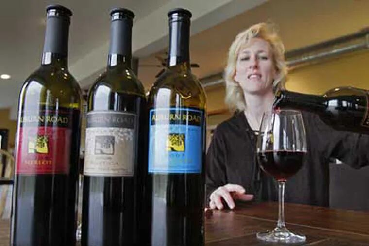 Shannon Kilpatrick pours wine from the Auburn Road Vineyard. ( Elizabeth Robertson / Staff Photographer)