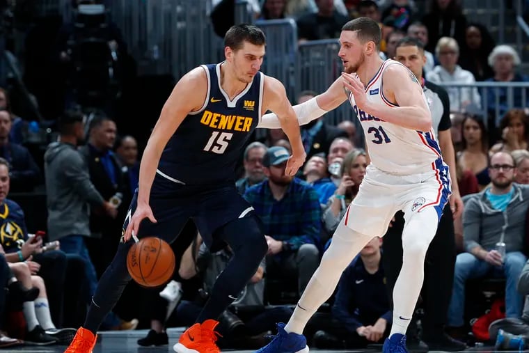 Mike Muscala tries to defend the Nuggets' Nikola Jokic on Saturday.