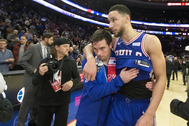 TJ McConnell and Ben Simmons (right) of the Sixers walk off the court after their victory over the Spurs.